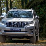 ed Toyota Fortuner SUV driving on a scenic mountain road in Nepal