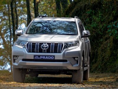 ed Toyota Fortuner SUV driving on a scenic mountain road in Nepal