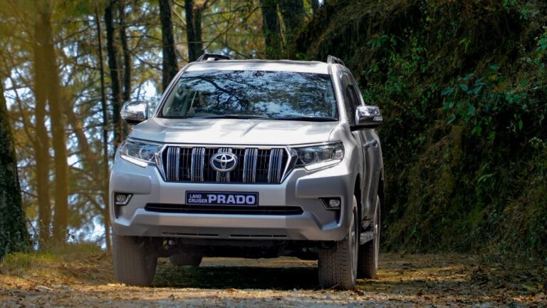 ed Toyota Fortuner SUV driving on a scenic mountain road in Nepal
